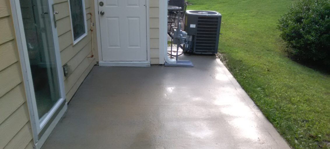 Newnan pressure washing on concrete to clean black stains.