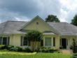 Here is a grey shingle roof in Sharpsburg, Ga covered with black stains.