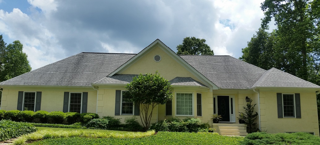 Here is a grey shingle roof in Sharpsburg, Ga covered with black stains.