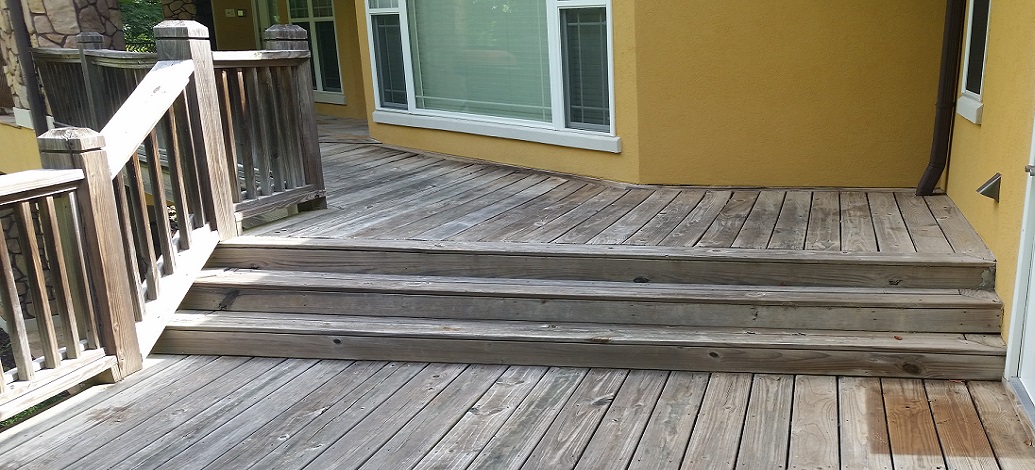 Wood deck grey fibers in need of pressure washing and staining in Newnan, Ga
